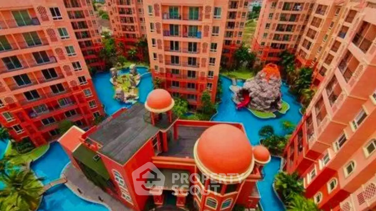 Stunning aerial view of vibrant apartment complex with unique architecture and lush surroundings.