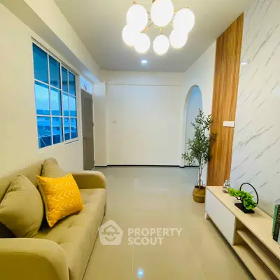 Modern living room with stylish decor and cozy sofa in bright apartment.