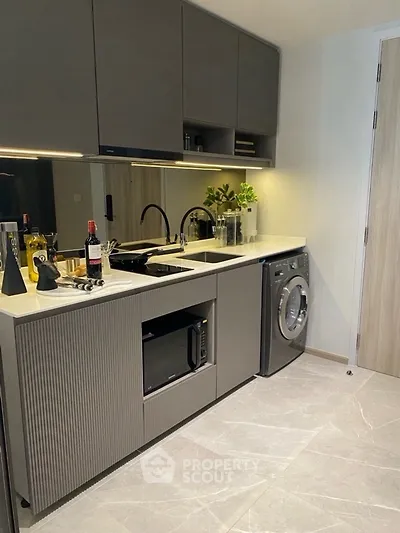 Modern kitchen with sleek cabinetry, built-in appliances, and stylish decor