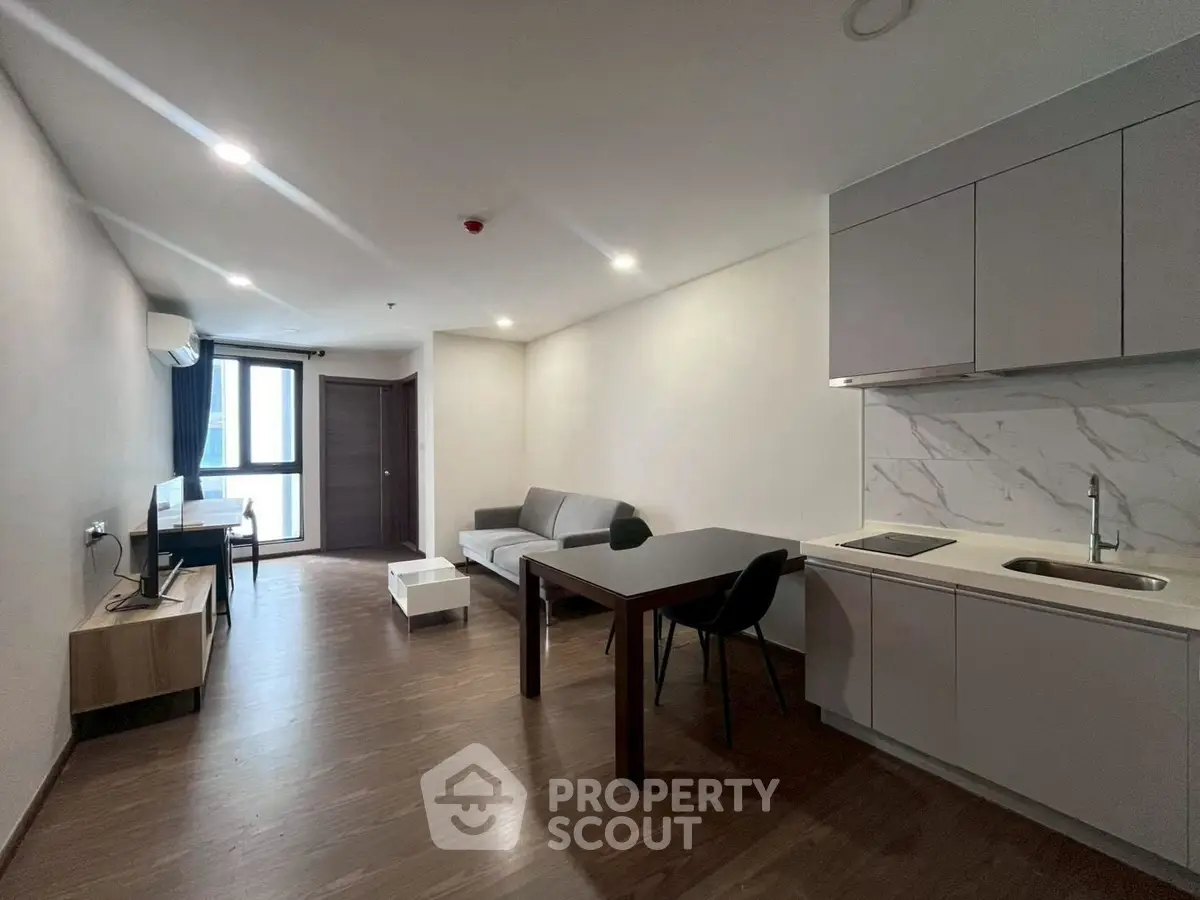 Modern open-plan living room with kitchen in stylish apartment