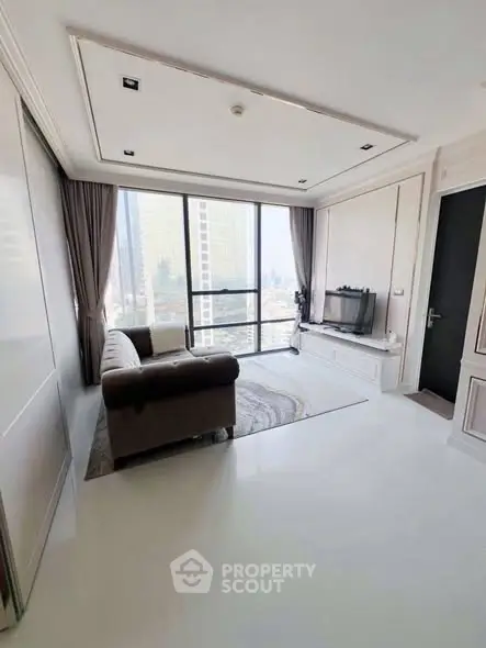 Elegant living room with city view, featuring modern decor and large windows.