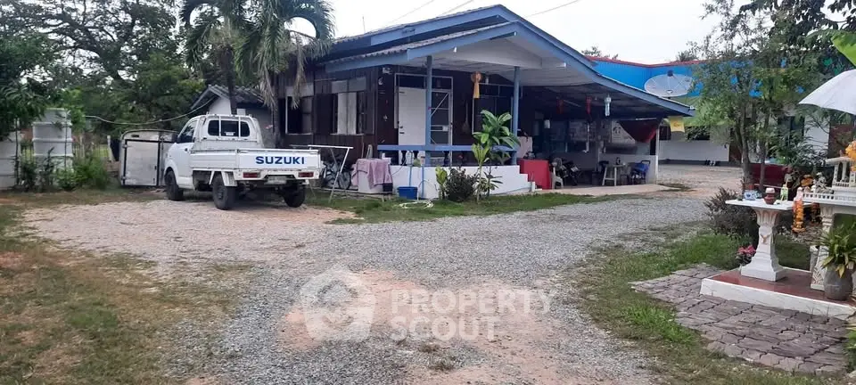 Charming rural property with spacious yard and cozy outdoor seating area.