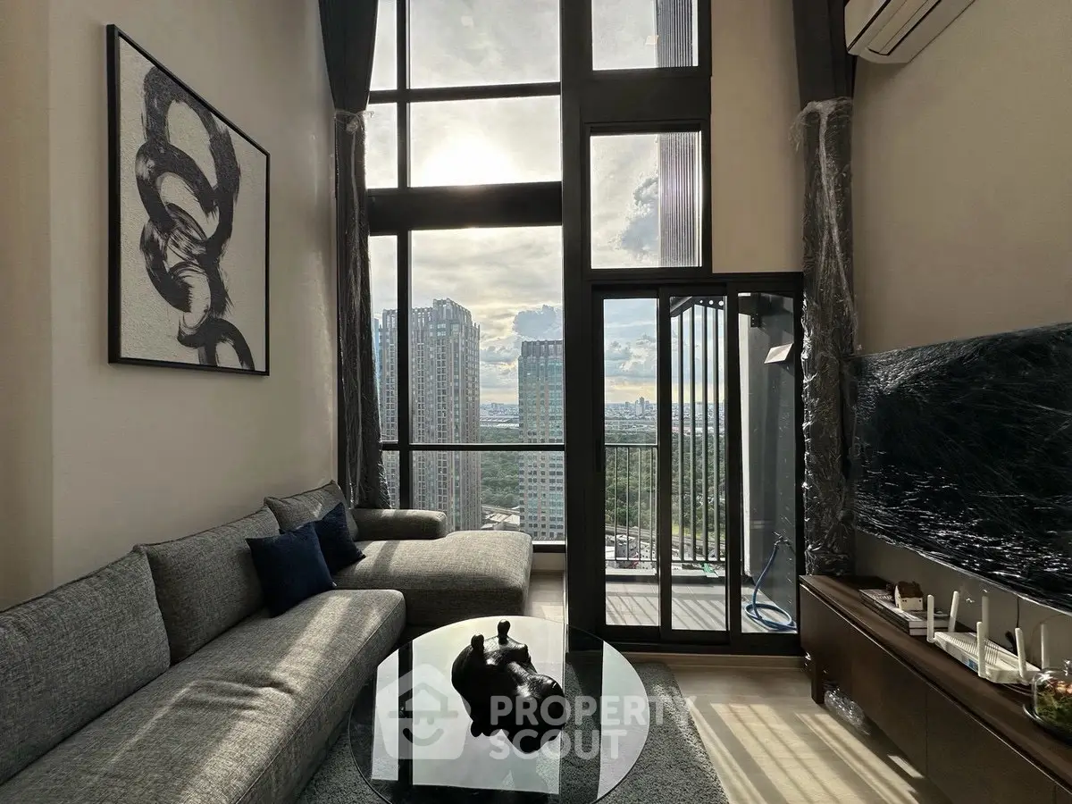 Luxurious high-rise living room with floor-to-ceiling windows and stunning city view.