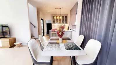 Modern dining area with elegant decor and open kitchen layout