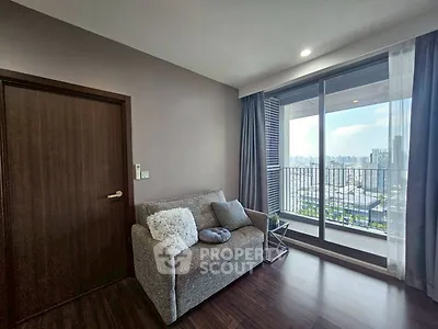Modern living room with cozy sofa and city view balcony in high-rise apartment