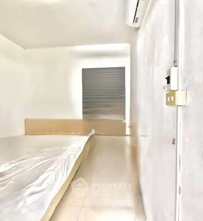 Minimalist bedroom with air conditioning and neutral tones