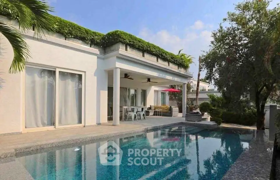 Luxurious villa with private pool and lush greenery, perfect for serene living.