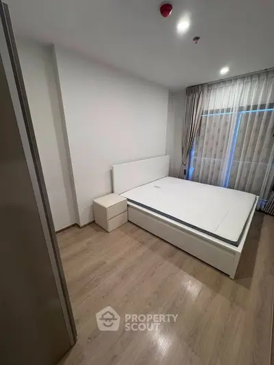Modern bedroom with minimalist design and large window for natural light