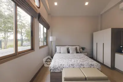 Spacious bedroom with large windows and modern decor, offering serene views and ample natural light.