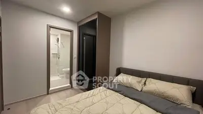 Modern bedroom with ensuite bathroom and sleek wardrobe design.