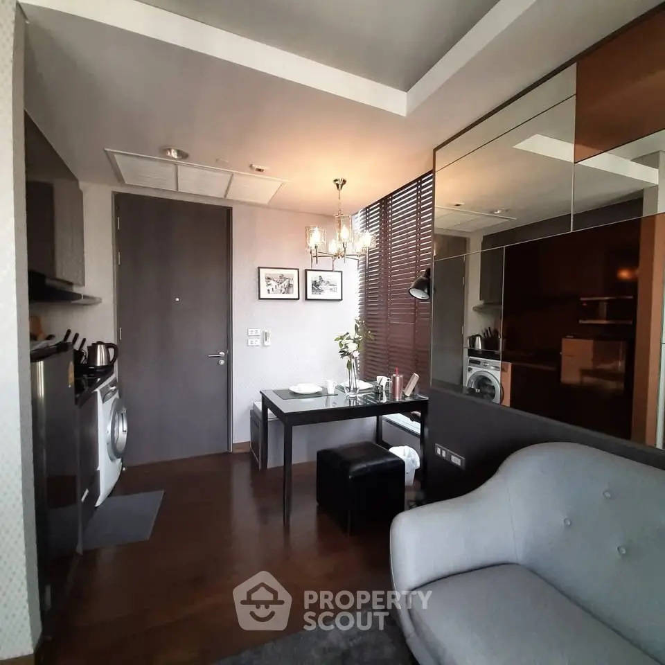 Modern living room with stylish decor and integrated kitchen appliances in a cozy apartment.