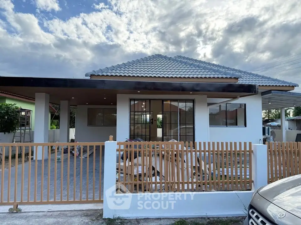 Charming single-story house with modern design and spacious front yard