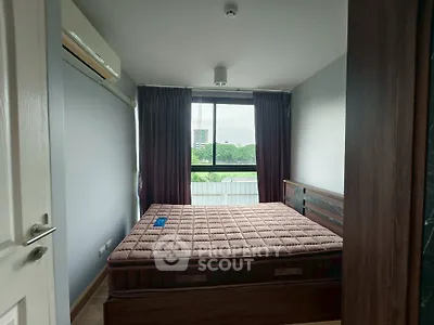 Cozy bedroom with large window and scenic view, featuring a comfortable bed and air conditioning.