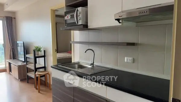Modern kitchen with sleek cabinetry and open layout in a stylish apartment.