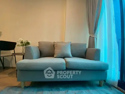 Cozy living room with stylish gray sofa and elegant curtains