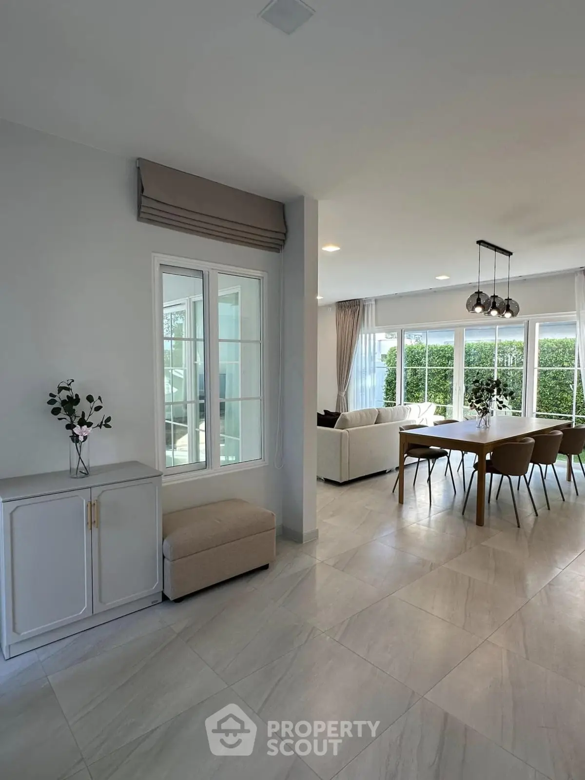 Spacious modern living room with elegant dining area and large windows