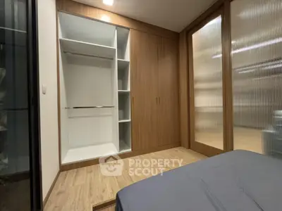 Modern bedroom with built-in wardrobe and wooden flooring