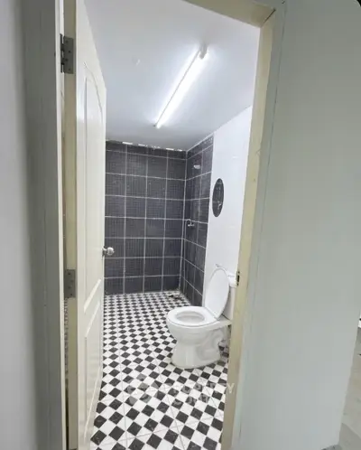 Modern bathroom with checkered floor tiles and sleek design