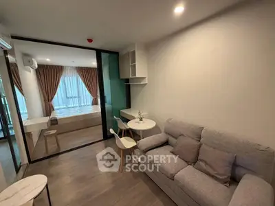 Modern living room with cozy sofa and dining area in open-plan apartment