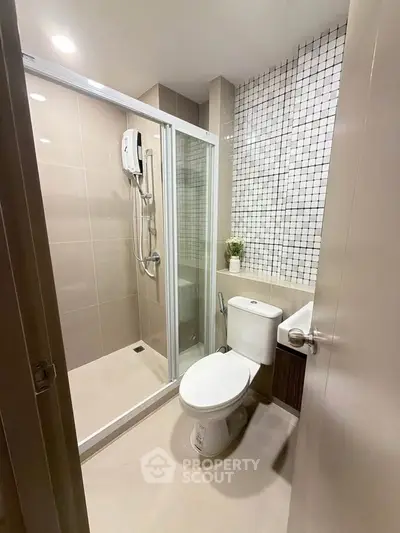Modern bathroom with glass shower enclosure and stylish tile design