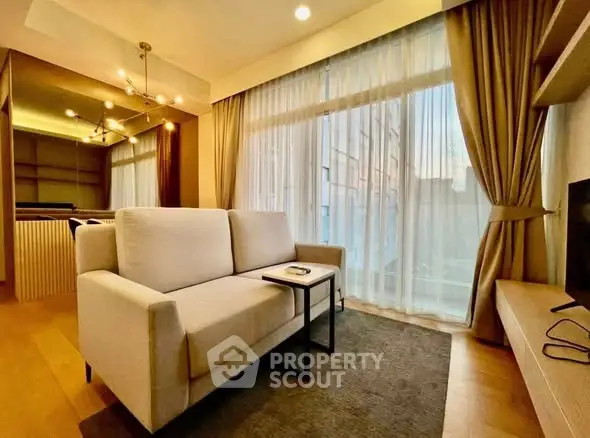 Modern living room with elegant decor and large window, featuring a cozy sofa and stylish lighting.