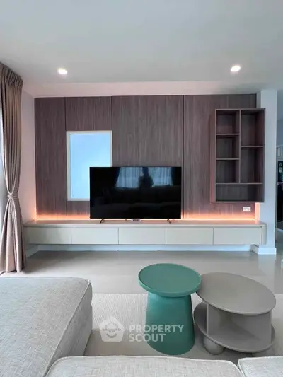 Modern living room with sleek TV unit and stylish furniture