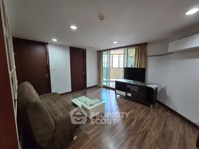 Spacious living room with modern furnishings and large windows for natural light.