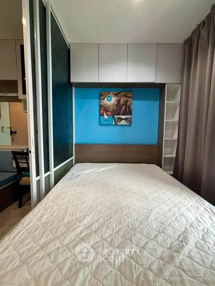 Modern bedroom with stylish decor and built-in storage solutions.