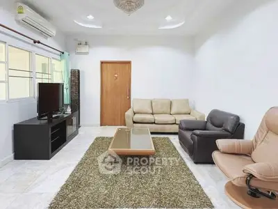 Spacious living room with modern furniture and natural light.