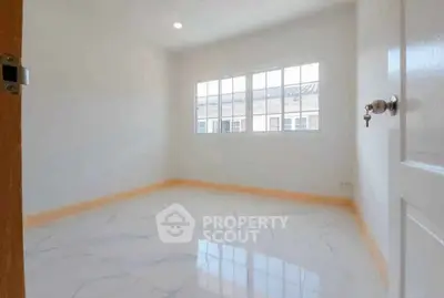 Bright empty room with large window and glossy tiled floor, perfect for customization.