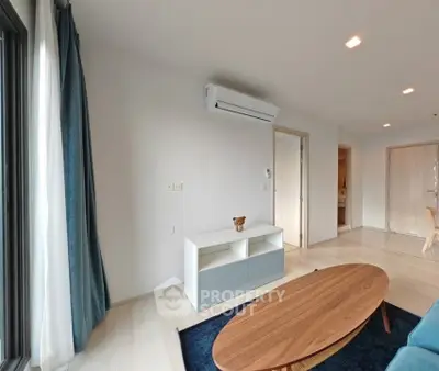 Modern living room with sleek furniture and air conditioning in a stylish apartment.