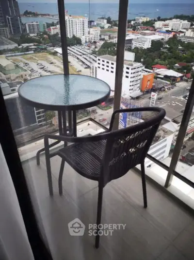 Stunning high-rise balcony with city and ocean views, perfect for relaxation.