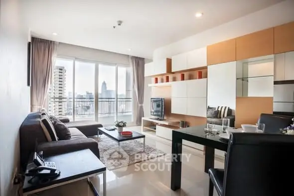 Modern living room with city view, stylish furniture, and ample natural light.