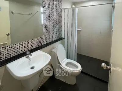 Modern bathroom with sleek fixtures and stylish tile accents