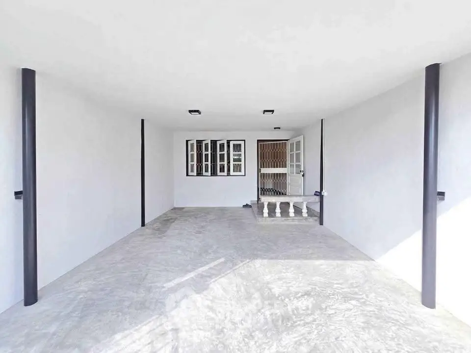 Spacious covered parking area with modern design and ample natural light.