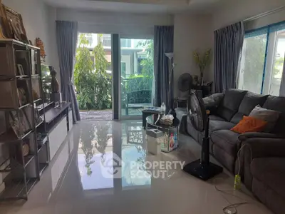 Spacious living room with modern decor and garden view