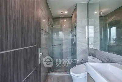 Luxurious modern bathroom with glass shower and sleek fixtures