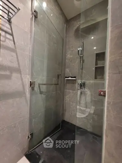 Modern bathroom with sleek glass shower enclosure and elegant tile design