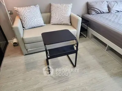 Modern studio apartment with cozy sofa and stylish bed, perfect for urban living.