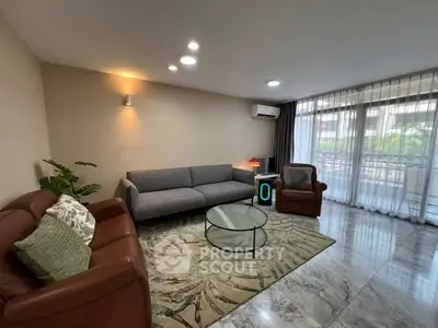 Spacious living room with modern furniture and large windows for natural light.