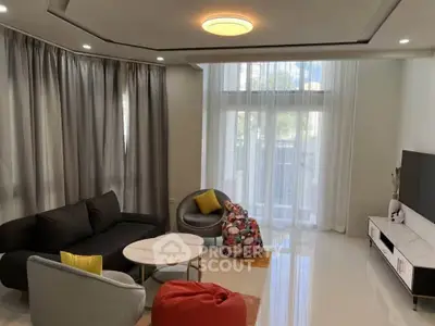 Modern living room with stylish furniture and large windows for natural light.