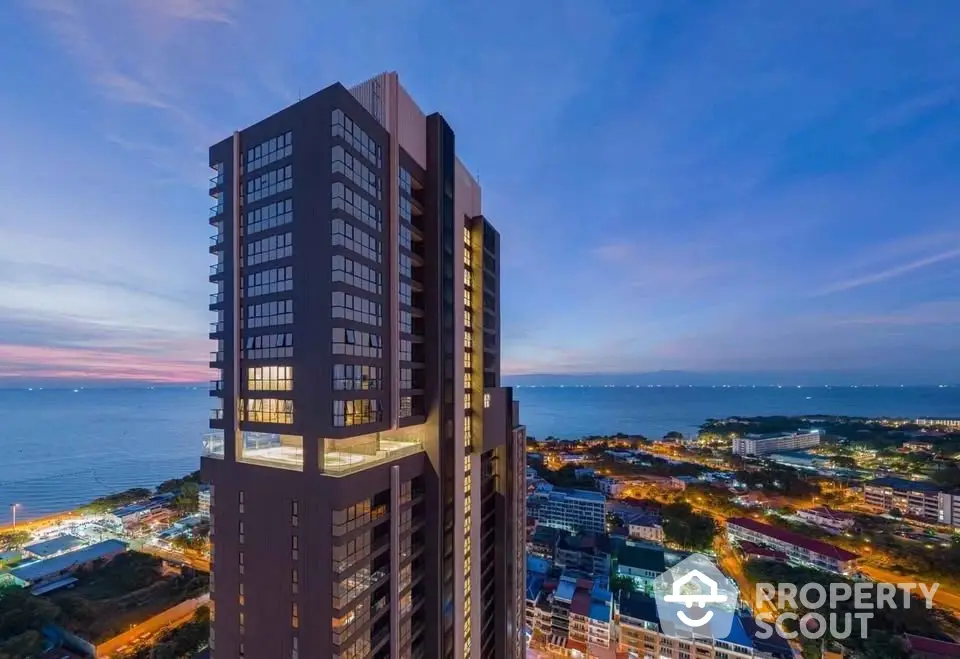 Stunning high-rise building with ocean view at sunset, perfect for luxury living.