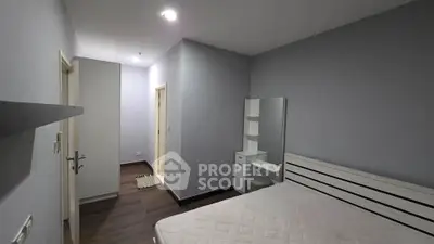 Spacious bedroom with modern design and ample natural light, featuring sleek furniture and elegant decor.