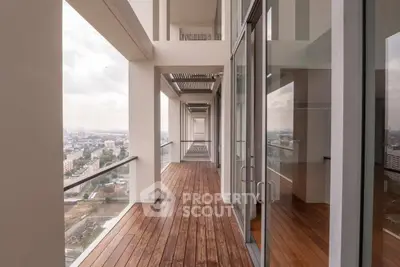 Stunning high-rise balcony with panoramic city views and elegant wooden flooring.