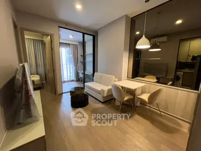 Modern living room with open layout, stylish furniture, and natural light in a contemporary apartment.