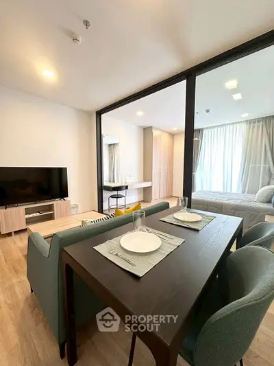 Modern open-plan living and dining area with stylish furniture and natural light.