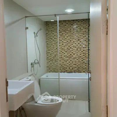 Modern bathroom with stylish tile accent wall and bathtub