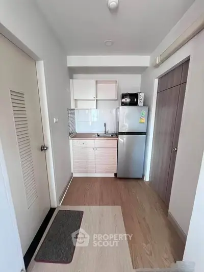 Compact kitchen with modern appliances in a cozy apartment setting