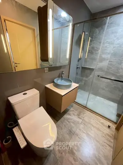 Modern bathroom with sleek fixtures and glass shower enclosure