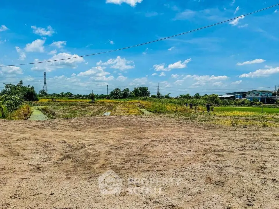 Expansive land plot with clear blue sky, ideal for development or agriculture.